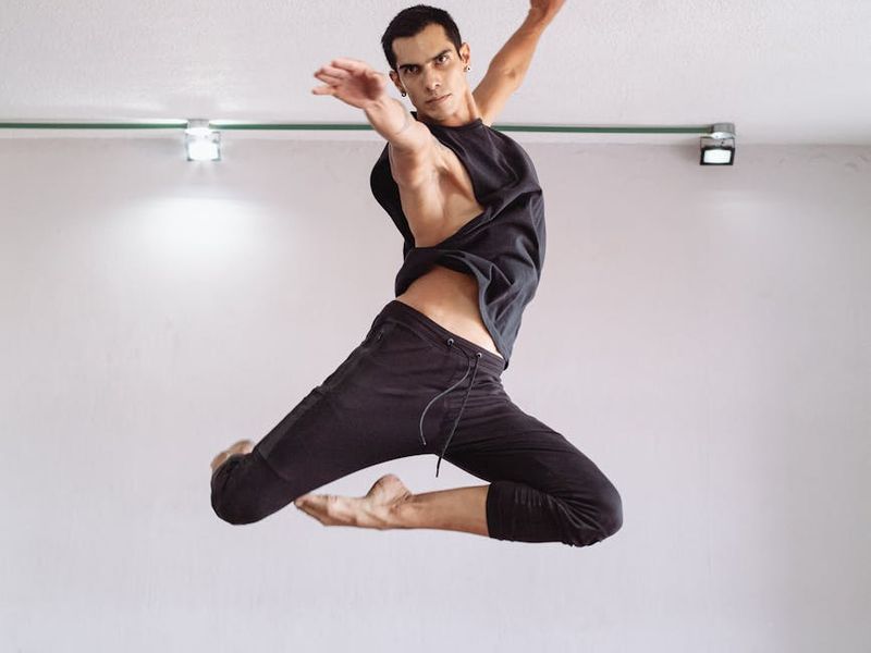 Athletic person moving smoothly in a professional studio setting